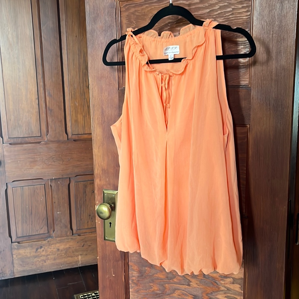 Large peach colored blouse, ties at the front, bunches at the bottom.